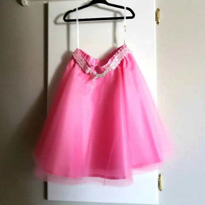  Pink Tulle Skirt with rhinestone buckle hanging on a hook image 0