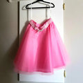  Pink Tulle Skirt with rhinestone buckle hanging on a hook image 0