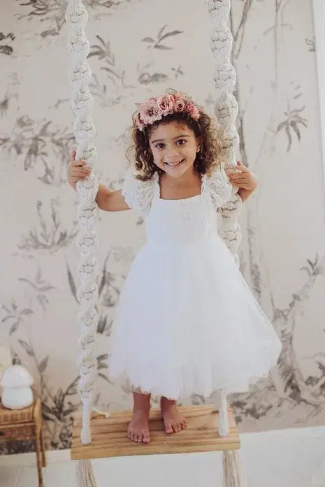 little girl on a swing wearing a White Lace Flower Girl Dress image 1