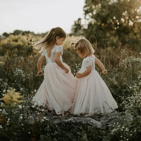 two models twirling in lace Flower Girl Dresses with V back image 4
