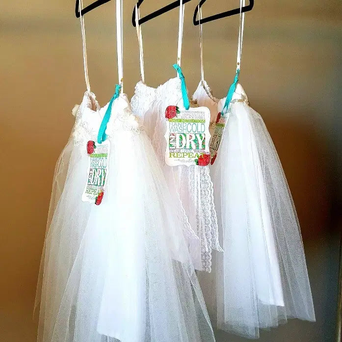 Side view of 3 White Tutu Skirts hanging on a rack image 1