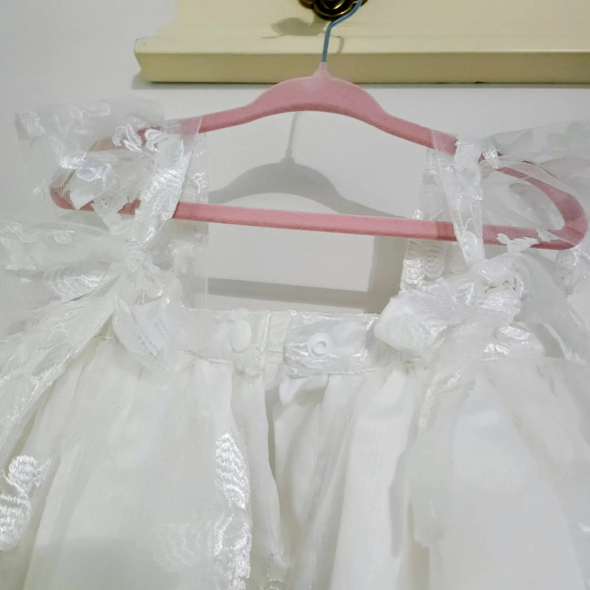 close up view of adjustable straps on a Babydoll Flower Girl Dresses image 2