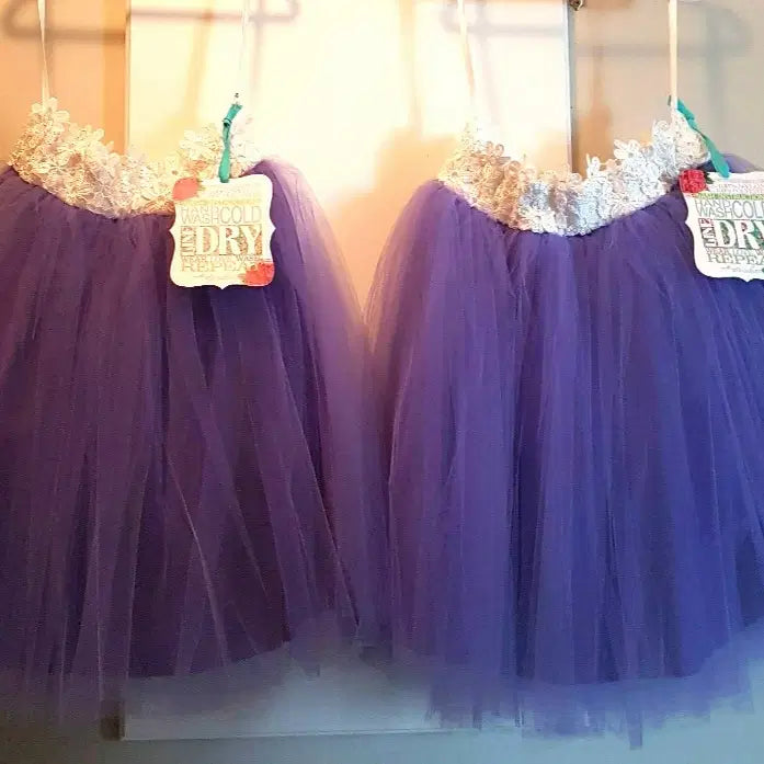 two Lavender Tutu Skirts hanging on a hook image 1
