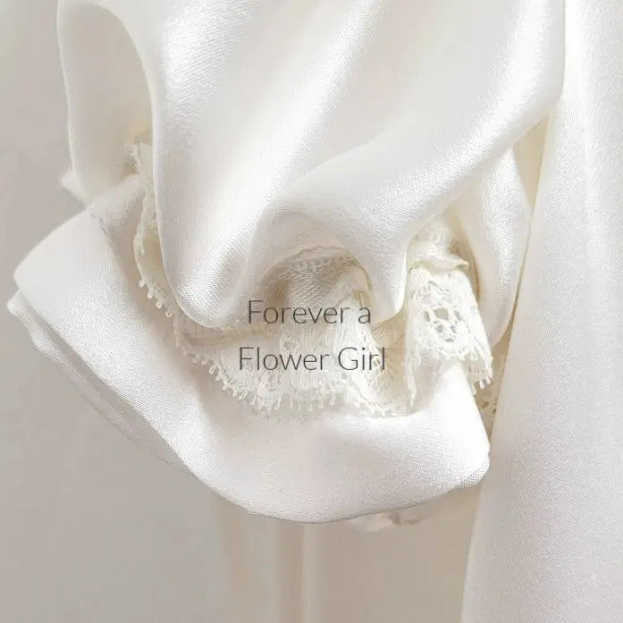 Close up view of lace on a sleeve of a Silk Satin Flower Girl Dress image 6