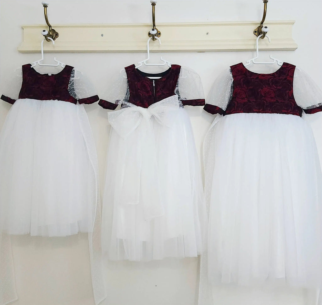 three Red and White Flower Girl Dresses hanging on a hook image 1